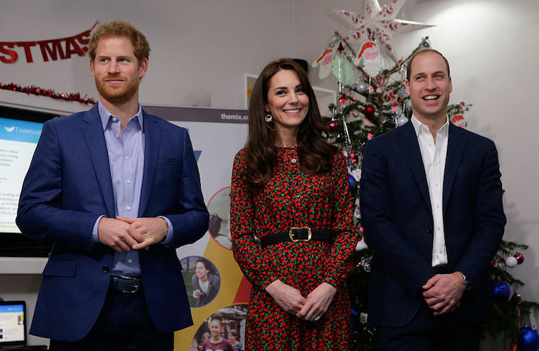 Prince Harry, Catherine, Duchess of Cambridge and Prince William, Duke of Cambridge stand ready to give an award during a visit to a Christmas party for volunteers at The Mix youth service on December 19, 2016 in London, England. The Mix youth service works with Their Royal Highnesses' Heads Together Campaign 