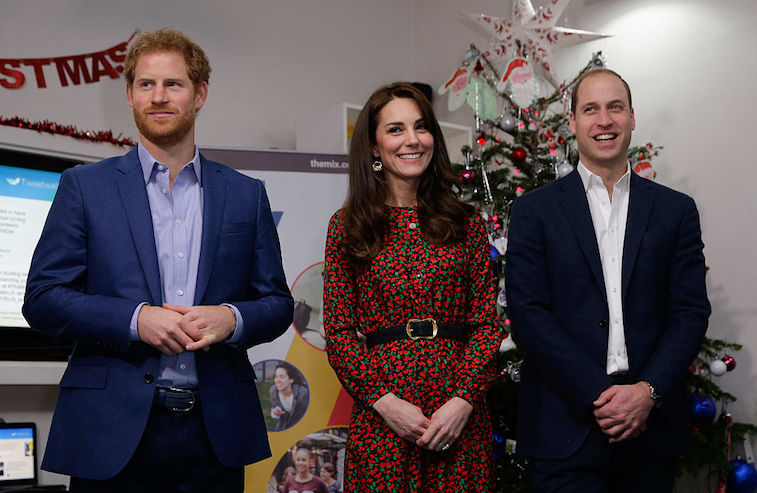 Prince Harry, Catherine, Duchess of Cambridge and Prince William, Duke of Cambridge stand ready to give an award during a visit to a Christmas party for volunteers at The Mix youth service on December 19, 2016 in London, England. The Mix youth service works with Their Royal Highnesses' Heads Together Campaign