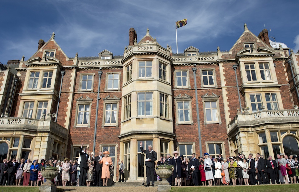 The royal family and guests stand in from of The Sandringham Estate.