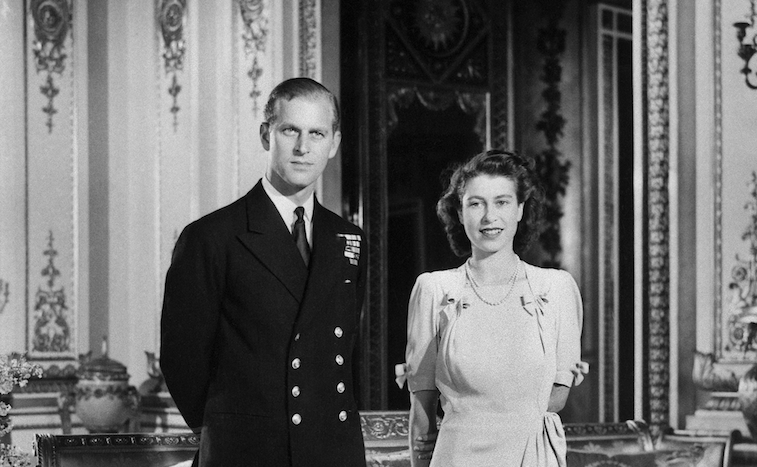 Princess Elizabeth stands next to Prince Phillip as she smiles and poses for a photograph.