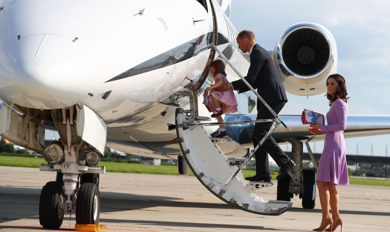 Kate Middleton boarding a plane with Prince Harry and her children.