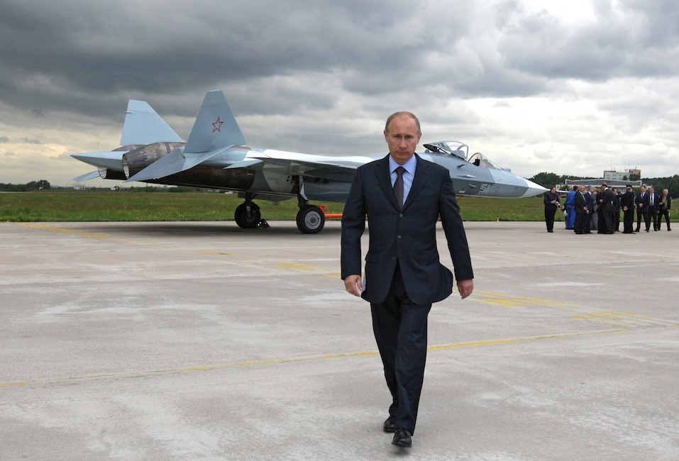 Russian Prime Minister Vladimir Putin walks near a new Russian fighter jet Sukhoi T-50