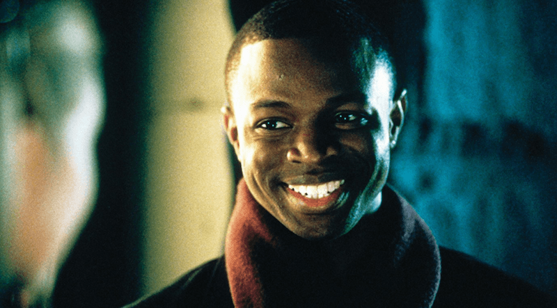 Derek smiling brightly while wearing a jacket and scarf. Derek smiling brightly while wearing a jacket and scarf.