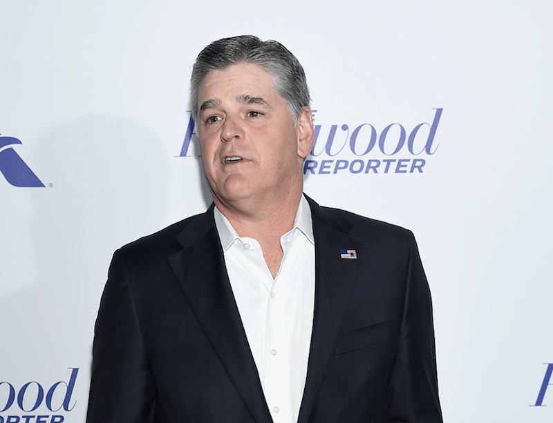 Sean Hannity posing for photographers at a red carpet event. Sean Hannity posing for photographers at a red carpet event.