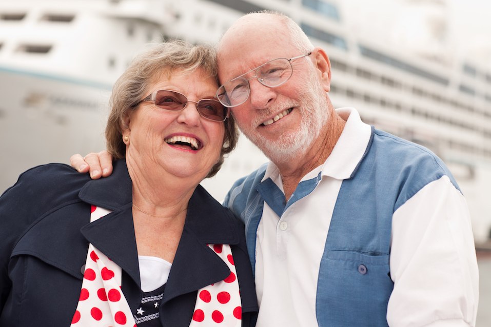 Senior Couple On Shore in Front of Cruise Ship
