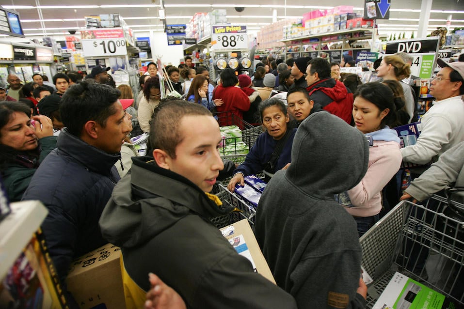 Shoppers try to work their way through the crowd that mobbed the Wal-Mart