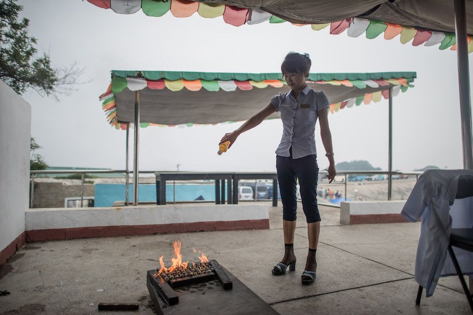 Hostess cooking clams using gasoline Hostess cooking clams using gasoline