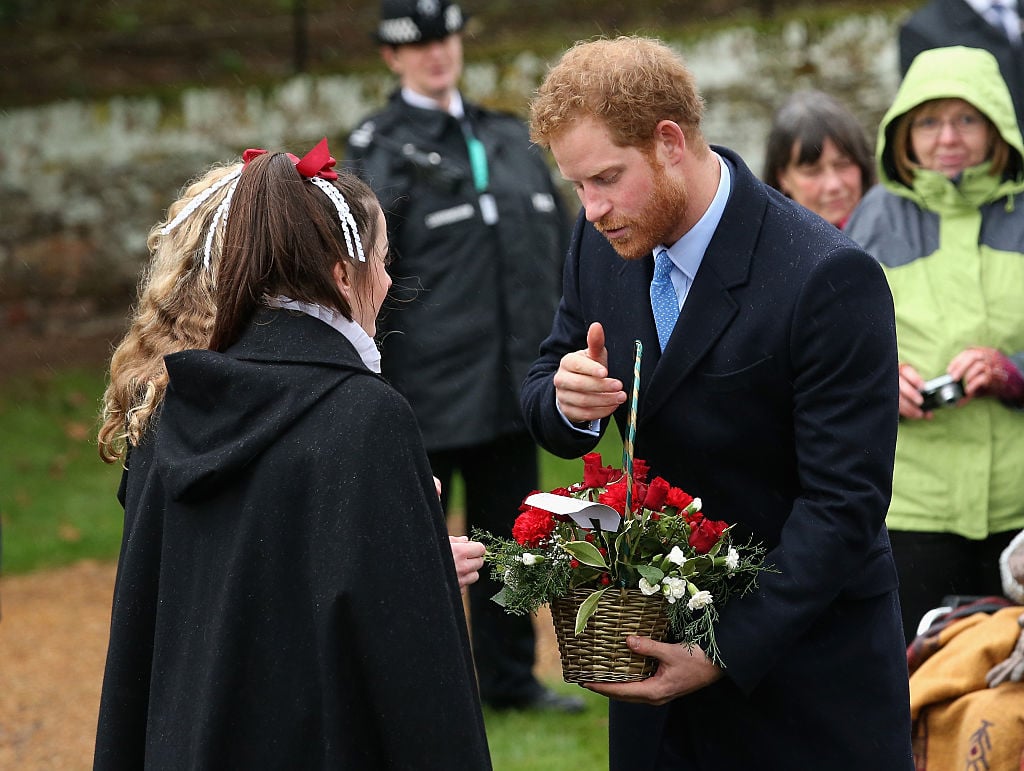 Prince Harry meets members of the public as he attends a Christmas Day church service. Prince Harry meets members of the public as he attends a Christmas Day church service.