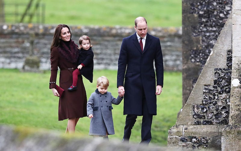 The royal family walking towards a church together.