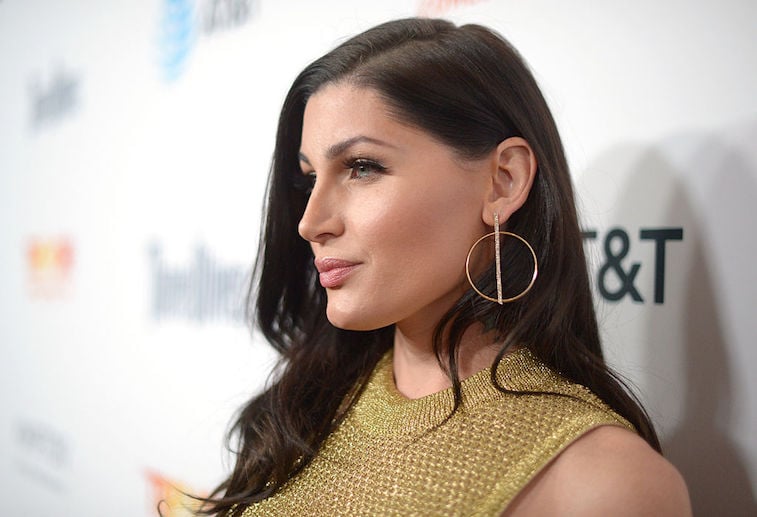 Trace Lysette poses in a gold dress and gold earrings. Trace Lysette poses in a gold dress and gold earrings.