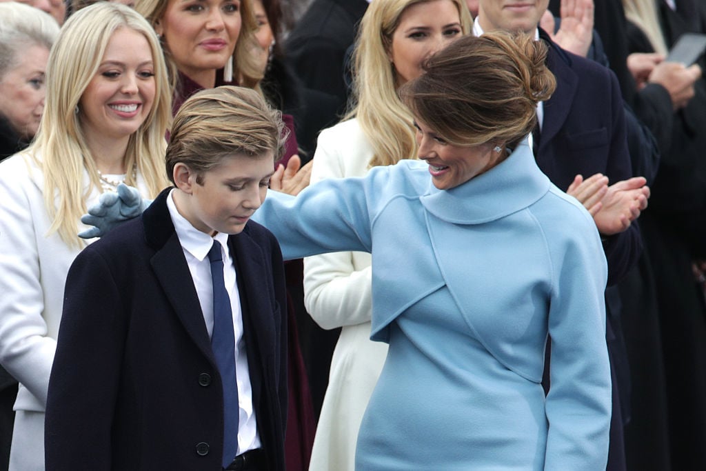 Melania with her hand around her son, Barron Trump.