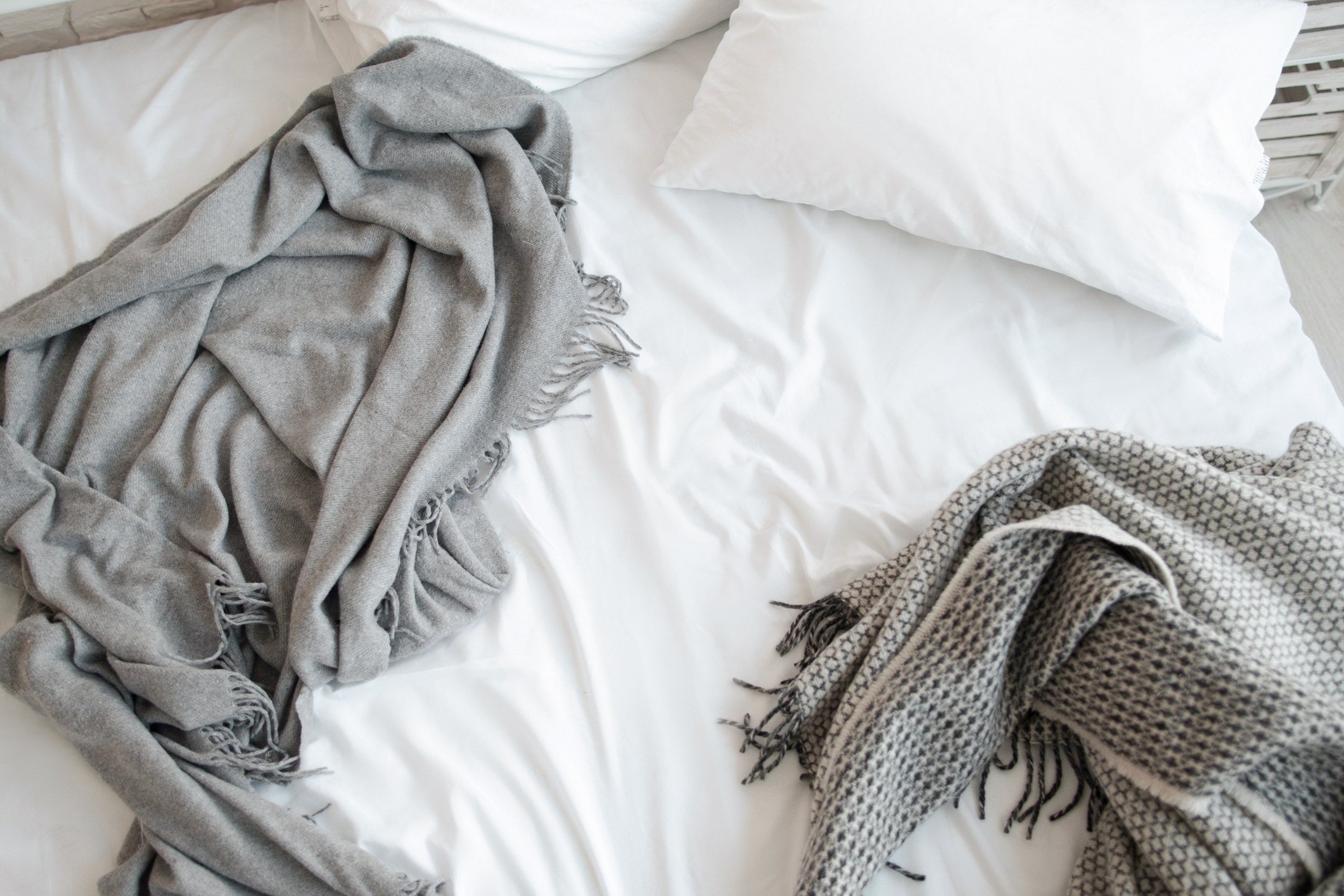 Unmade bed with blankets Unmade bed with blankets