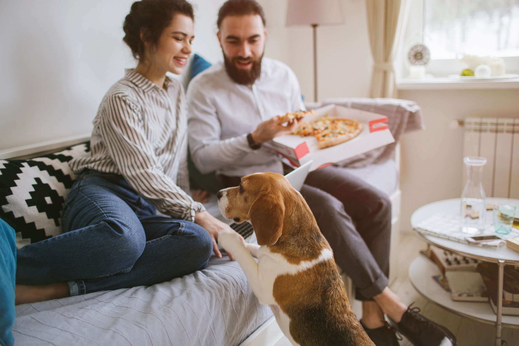 Couple with dog and pizza