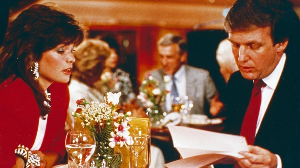 Donald Trump and Valerie Bertinelli sit at a table in I'll Take Manhattan