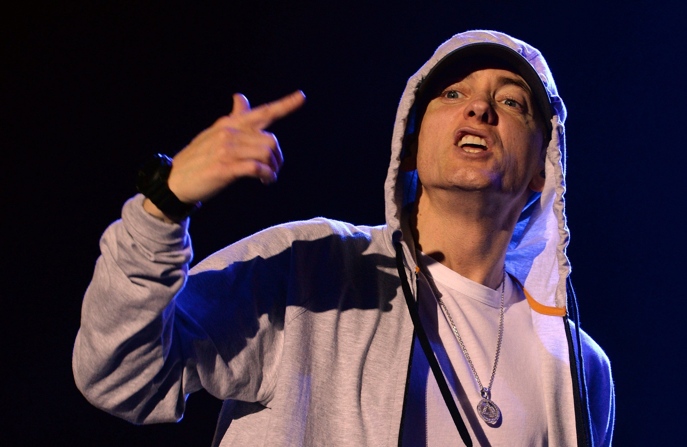 Rapper Eminem performing in a grey hoodie. 