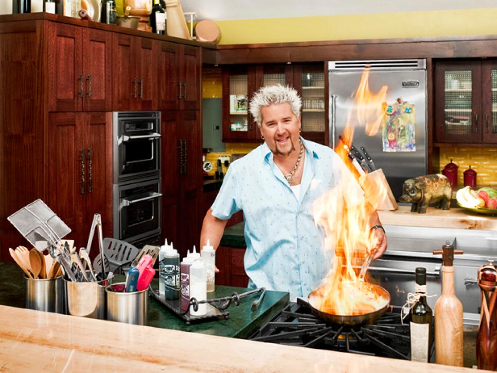 Guy Fieri cooking in a kitchen