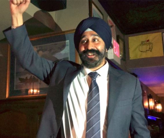 ravinder bhalla in a suit and tie and white shirt waves to the crowd ravinder bhalla in a suit and tie and white shirt waves to the crowd