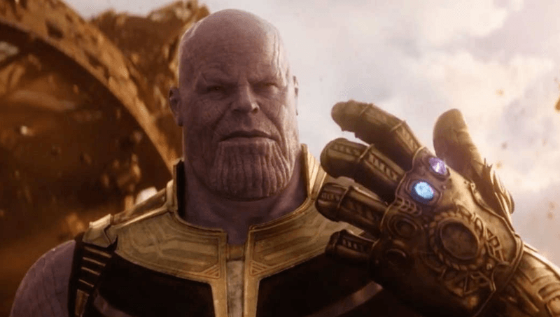 Thanos holds up an Infinity Gauntlet with two Infinity Stones