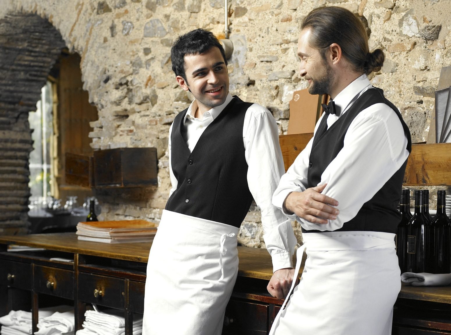 Two waiters talking in restaurant