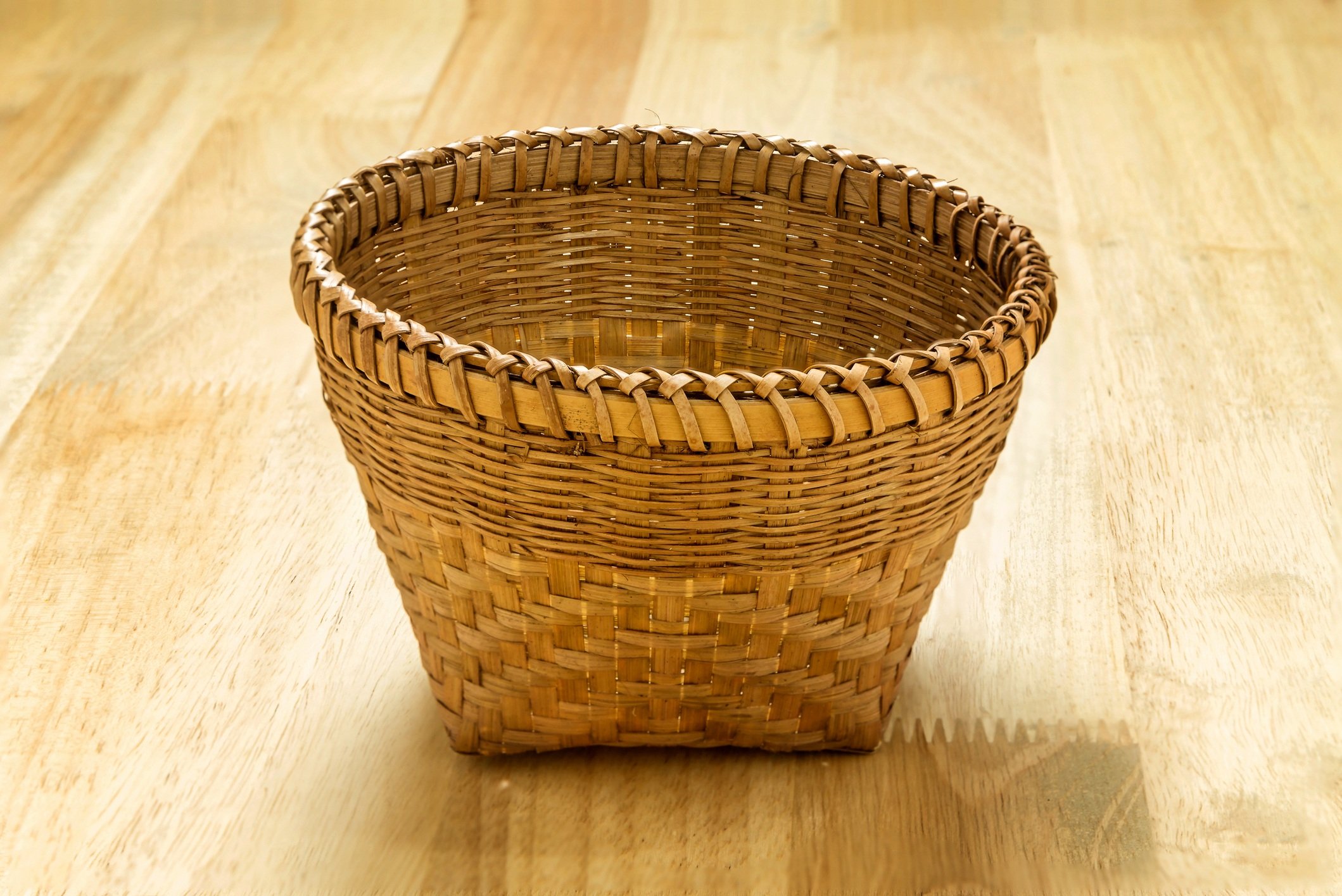 Wicker bamboo basket on wooden table