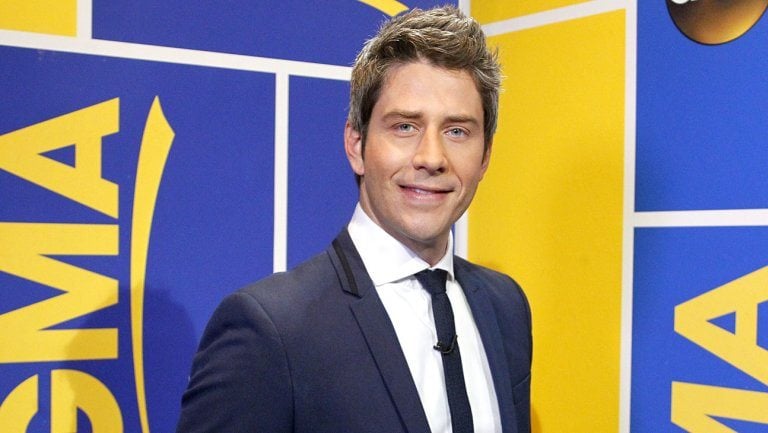 Arie Luyendyk Jr smiles while looking into a camera