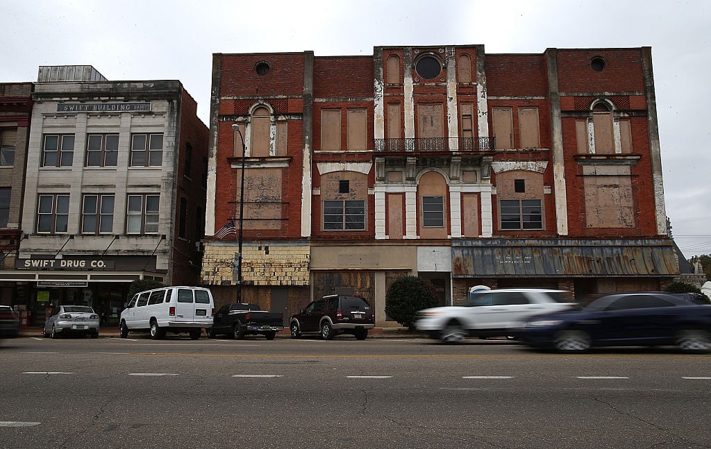 Cars drive by a boarded up building in Selma, Alabama. 50 years after the historic civil rights