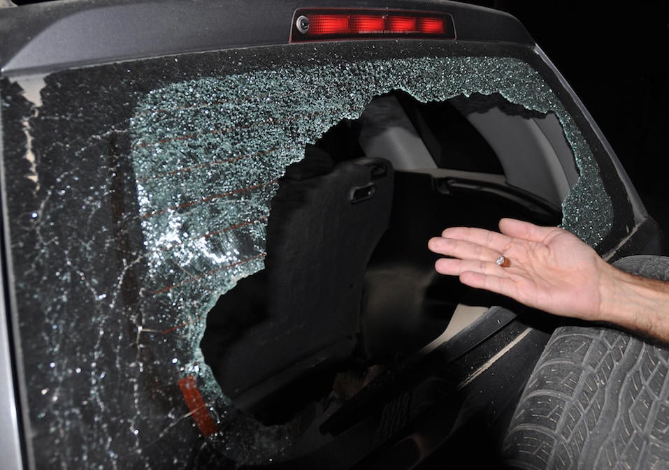 A man shows a smashed bullet found inside the car A man shows a smashed bullet found inside the car