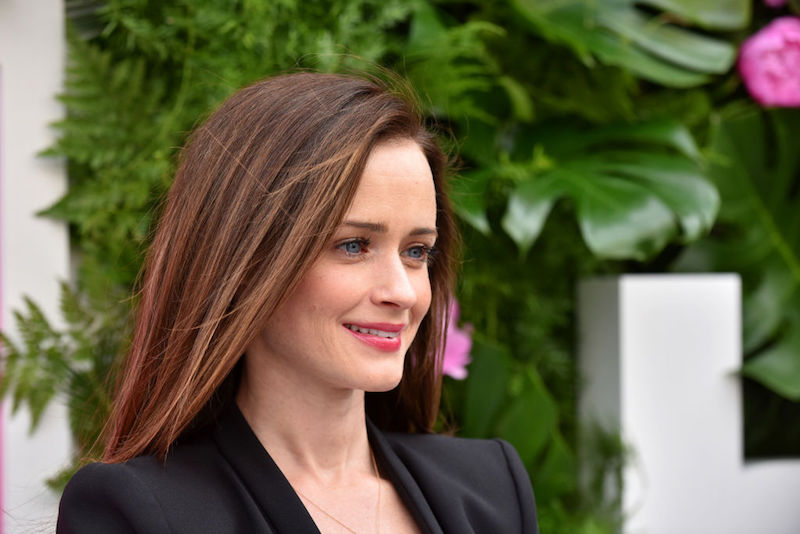 Alexis Bledel smiling while posing outdoors. Alexis Bledel smiling while posing outdoors.