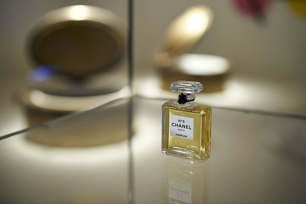 A miniature bottle of Chanel No. 5 perfume forms