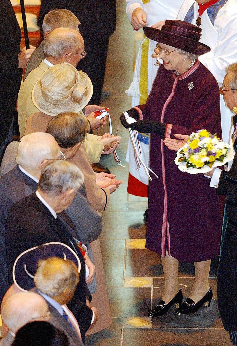 Britain's Queen Elizabeth II hands out maundy money during the Royal Maundy Service