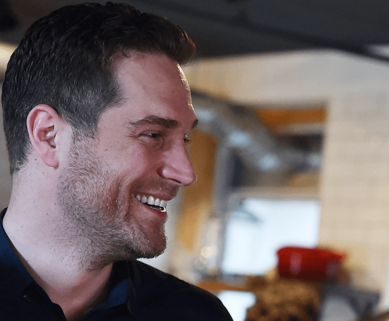 Cory Vitiello smiling while in a kitchen. 