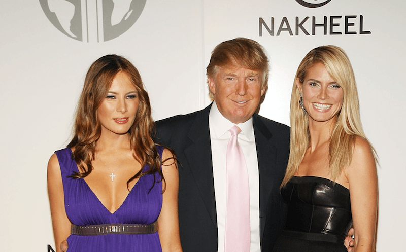 Melania Trump stands with Donald Trump and Heidi Klum.