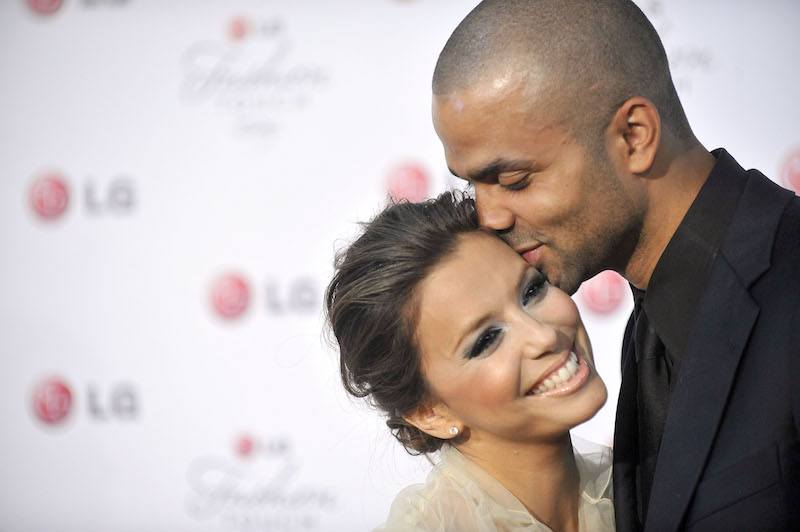 Eva Longoria is being kissed by Tony Parker. Eva Longoria is being kissed by Tony Parker.