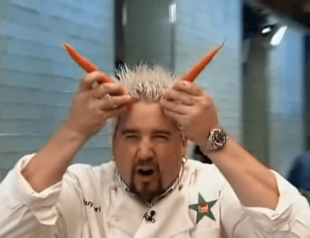 Guy Fieri holding carrots like antennae