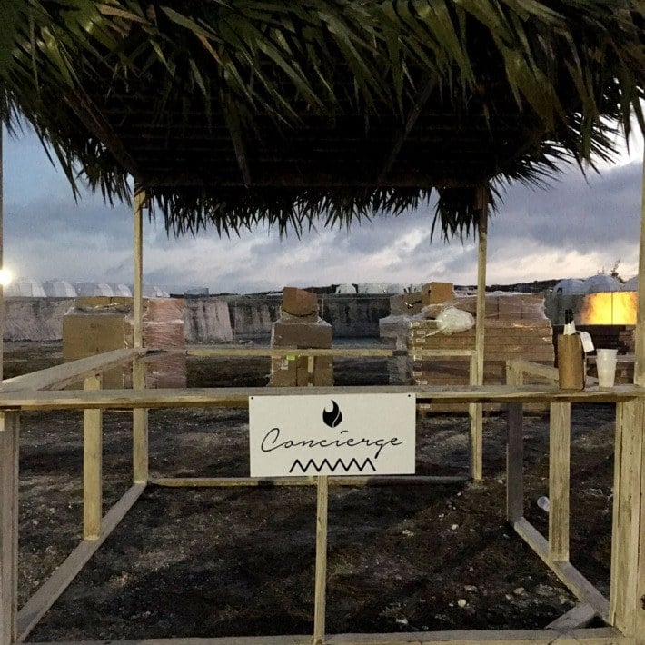 A partially built cabana with a concierge sign attached.