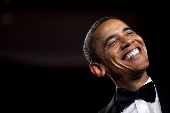 barack obama laughing in a black bow tie tuxedo