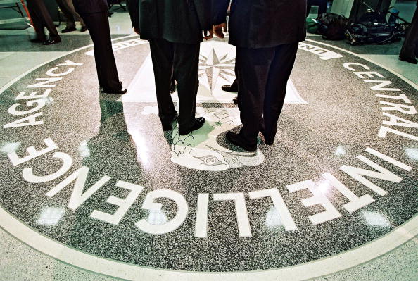 men in suits standing on the seal of the central intelligence agency at headquarters men in suits standing on the seal of the central intelligence agency at headquarters