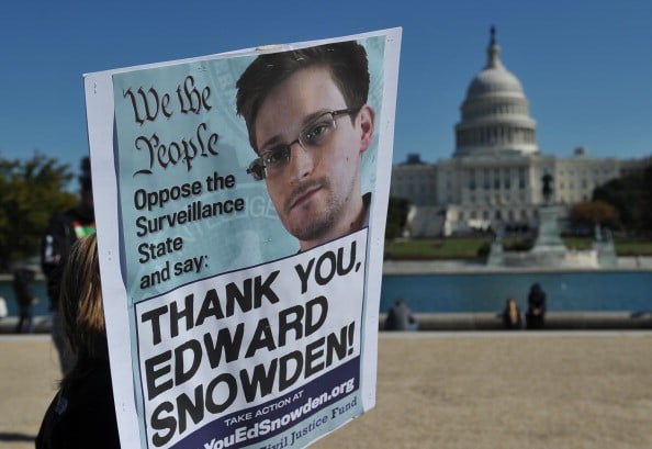 protestors hold a sign protesting mass surveillance outside the US capitol protestors hold a sign protesting mass surveillance outside the US capitol