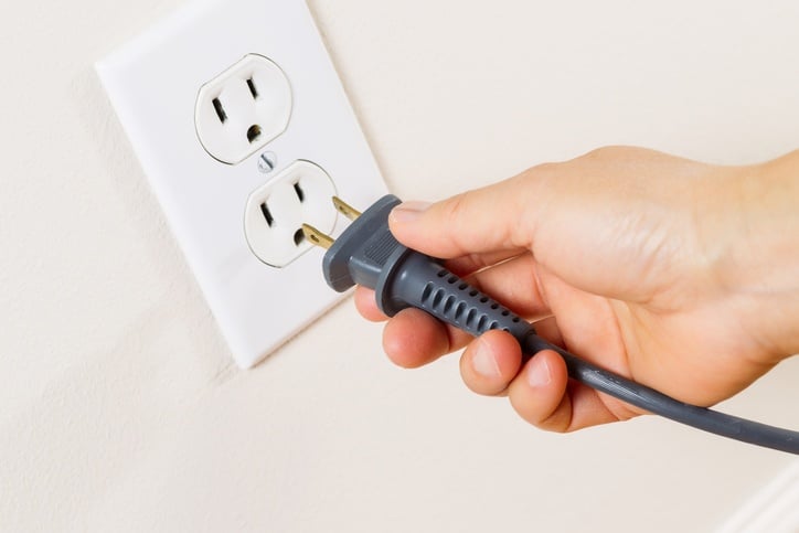 plugging cord into outlet