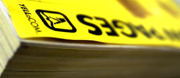 a close-up of the edge of a yellow pages phone book a close-up of the edge of a yellow pages phone book