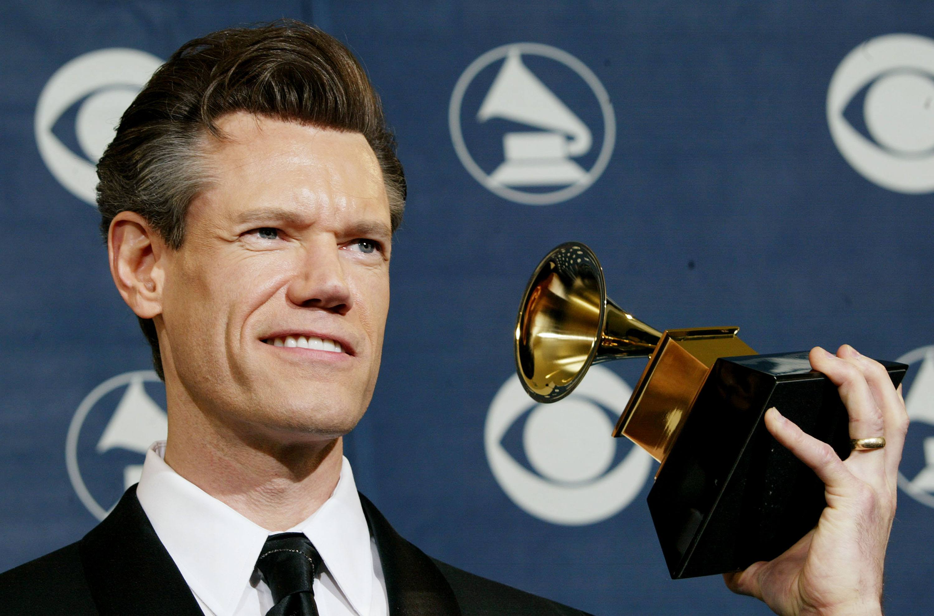 Randy Travis holding a Grammy Randy Travis holding a Grammy