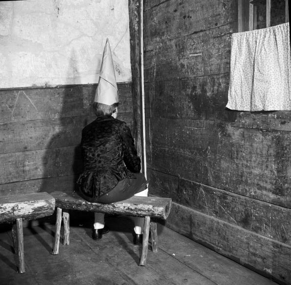 an old black and white photo of a boy in a dunce hat an old black and white photo of a boy in a dunce hat