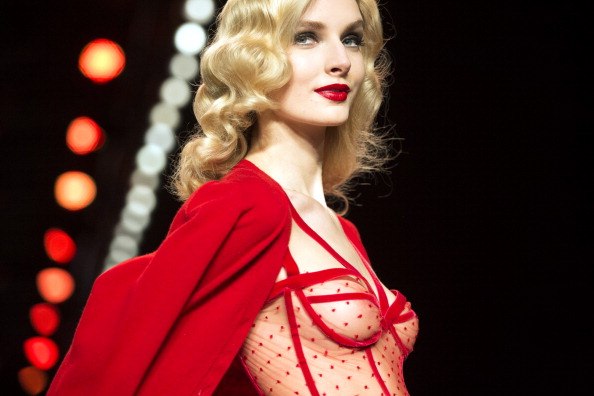 a model in a red negligee and a red cape a model in a red negligee and a red cape