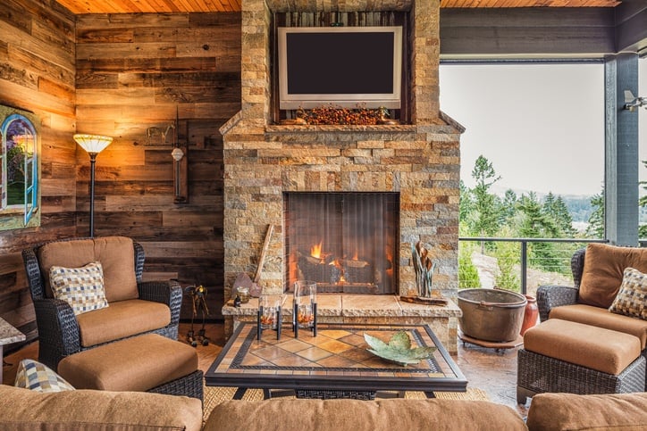 patio with a fireplace and tv hanging above the fireplace