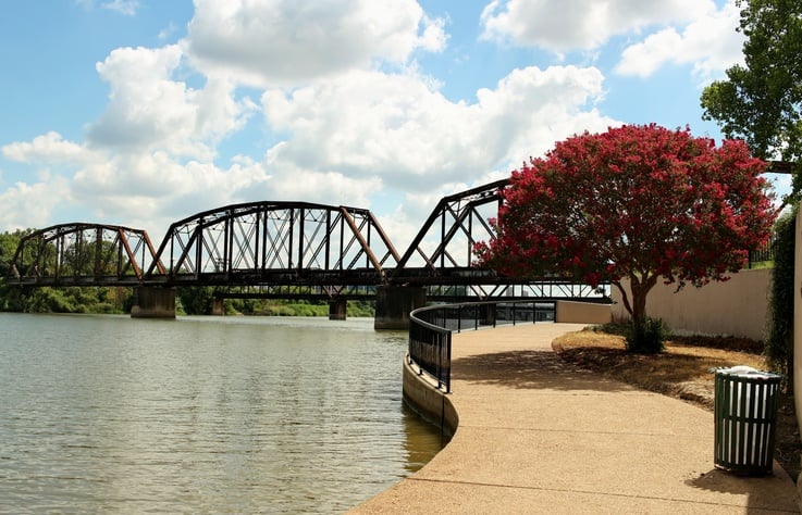 An old iron railroad bridge over the Brazos river near downtown Waco