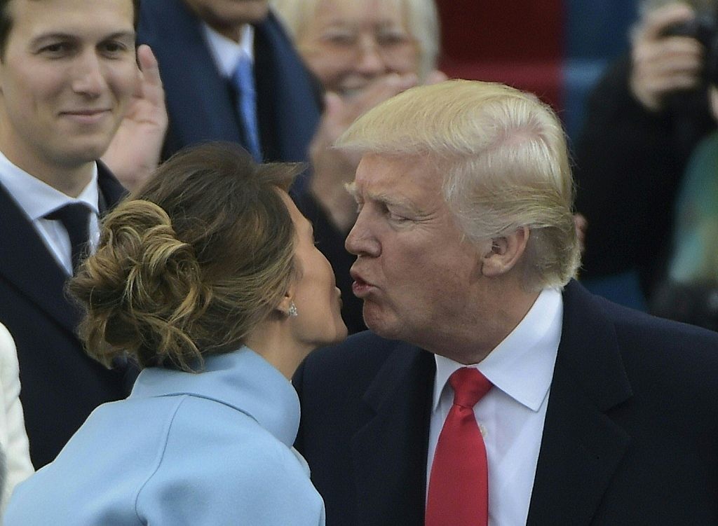 Melania Trump and Donald Trump kissing during his inauguration.