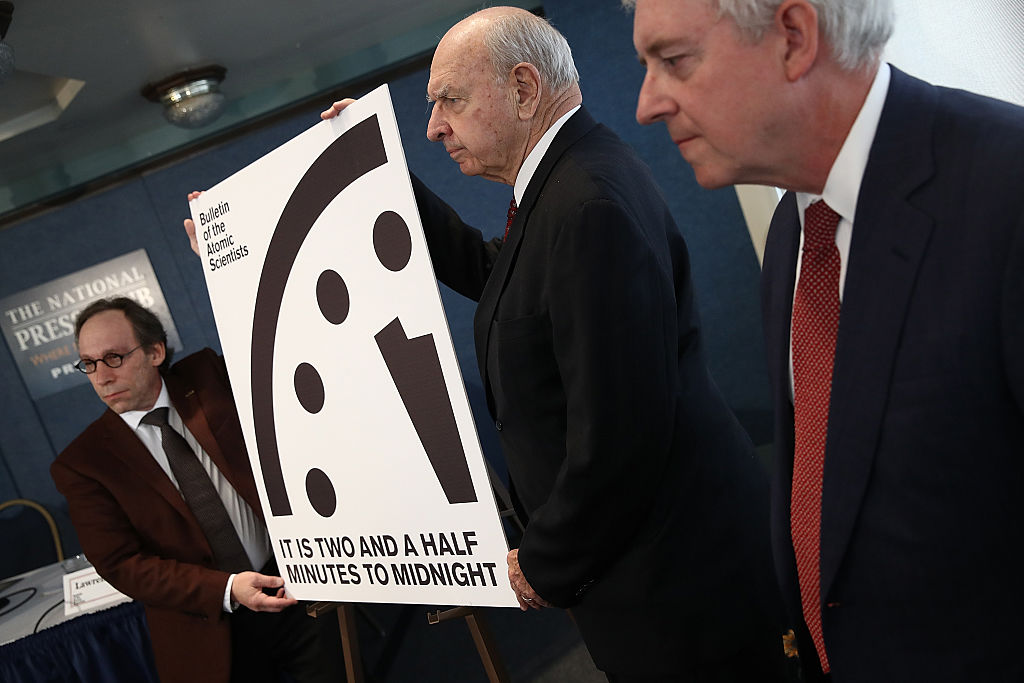 scientists display the atomic clock at two minutes and thirty seconds to midnight. scientists display the atomic clock at two minutes and thirty seconds to midnight.