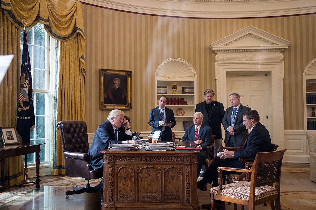 trump in the oval office surrounded by his cabinet