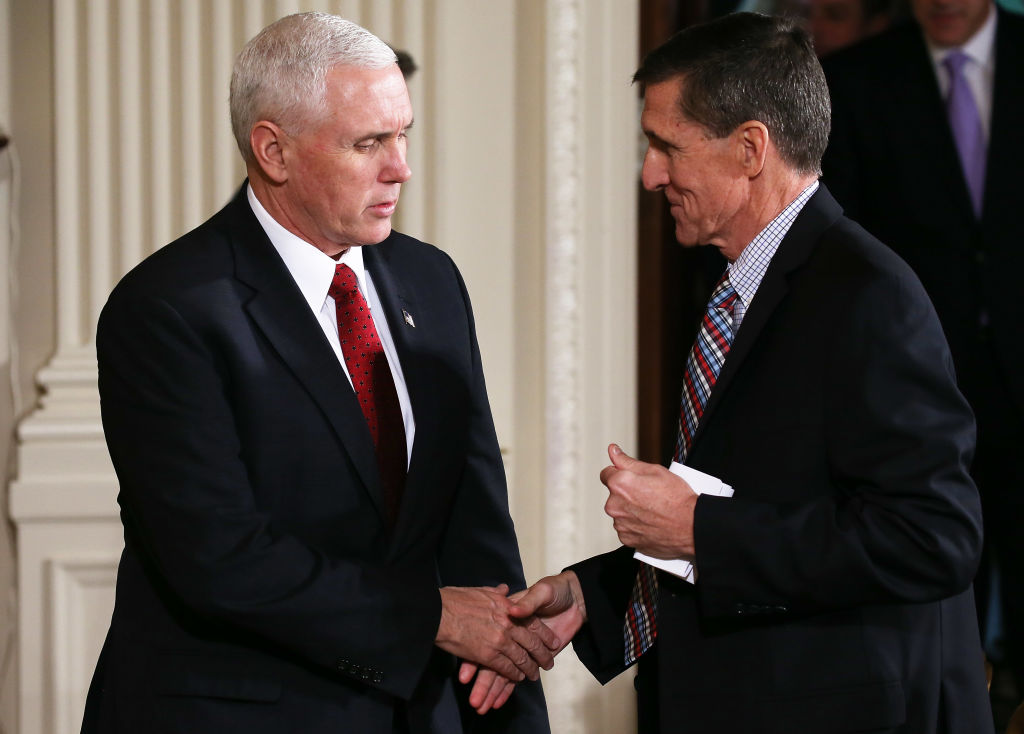 mike pence and michael flynn shake hands against white columns, both in dark suits mike pence and michael flynn shake hands against white columns, both in dark suits