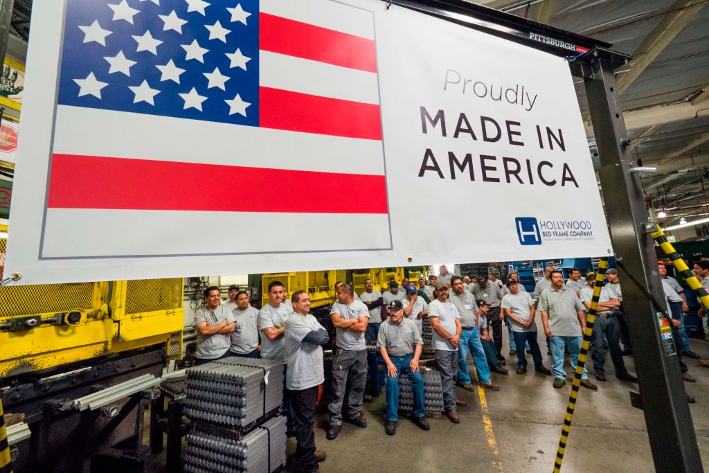 workers at the american bed frame company in front of a made in america sign workers at the american bed frame company in front of a made in america sign